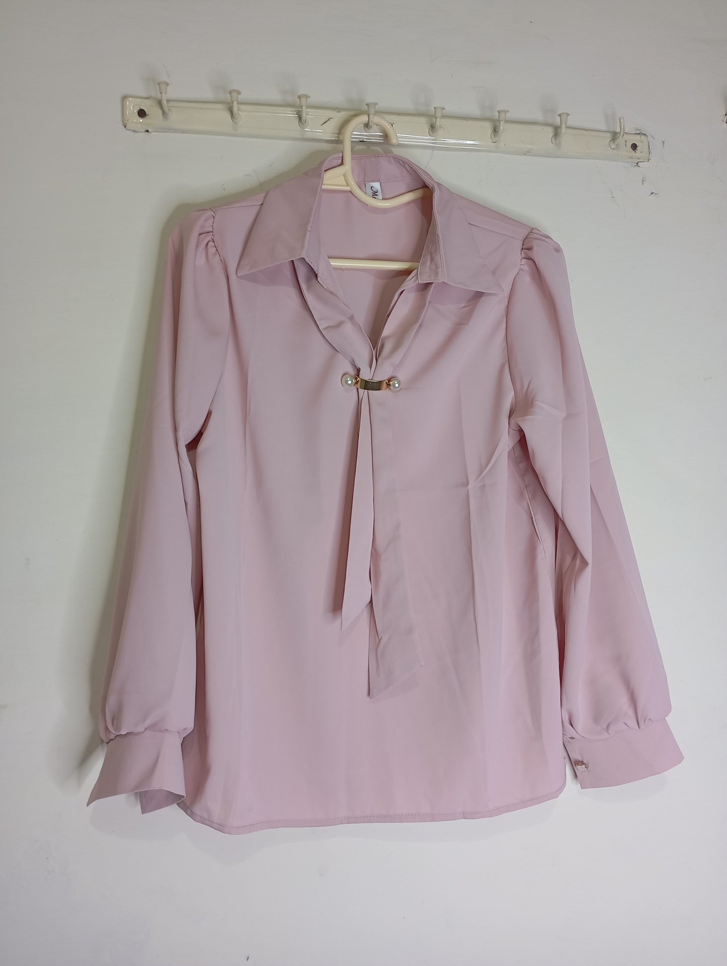 pink top with decorative tie