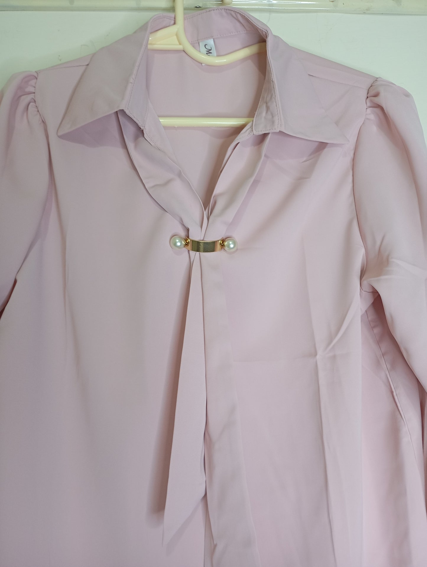pink top with decorative tie