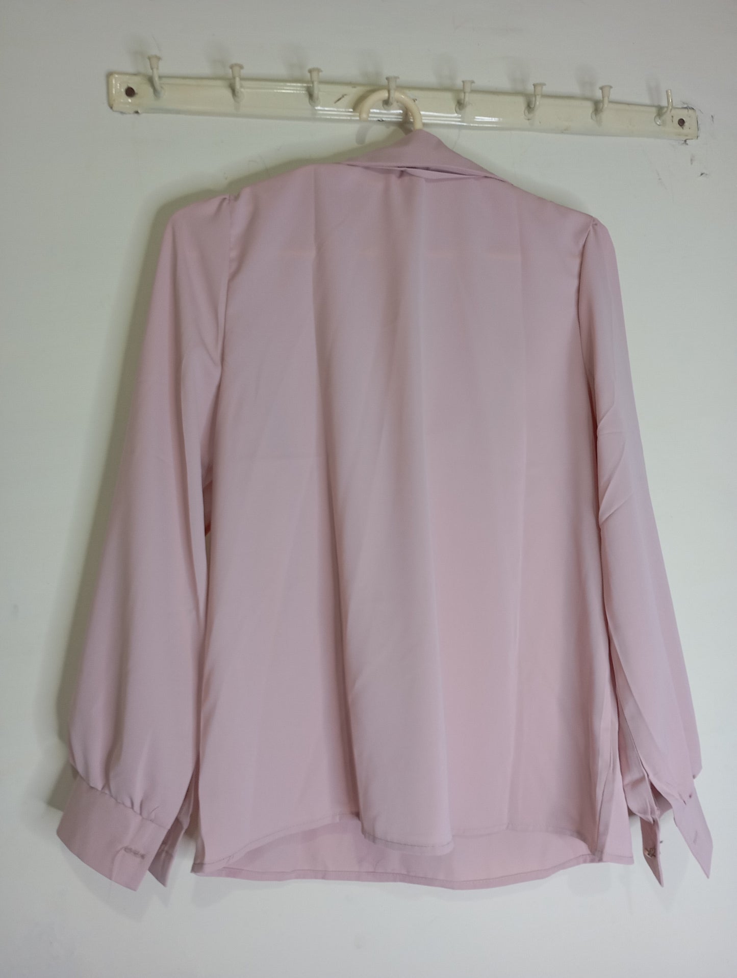 pink top with decorative tie